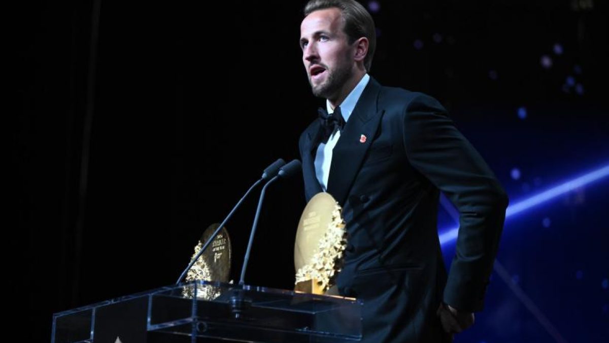 Harry Kane holding the 2026 Ballon d'Or trophy on stage at the London Palladium.